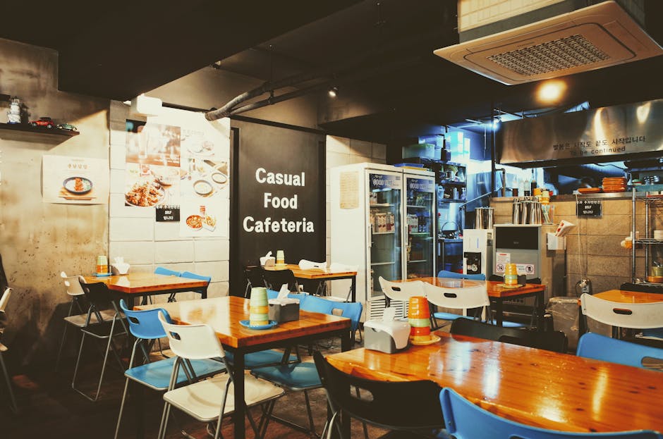 A cozy casual cafeteria interior with tables and chairs, located in Busan, South Korea